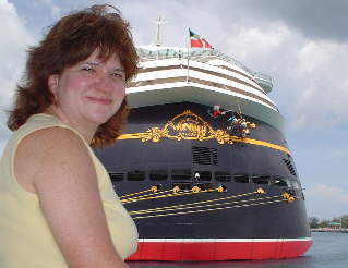 Linda sitting with the Disney Wonder in the background